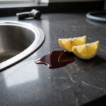 Red wine and lemon juice sitting harmlessly on a non-porous quartz worktop surface.
