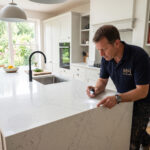 A modern British kitchen featuring a bespoke white quartz worktop installation.